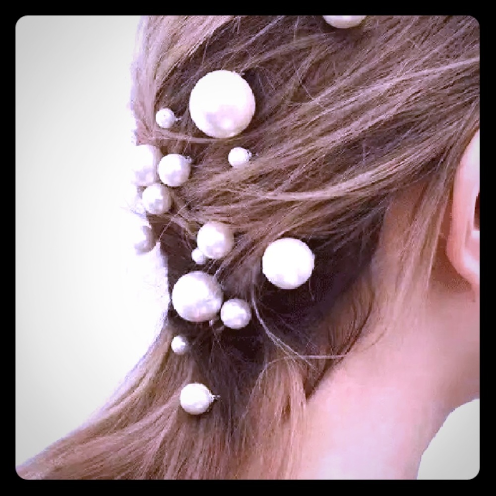 Multiple sizes of modern white ball hair pins.